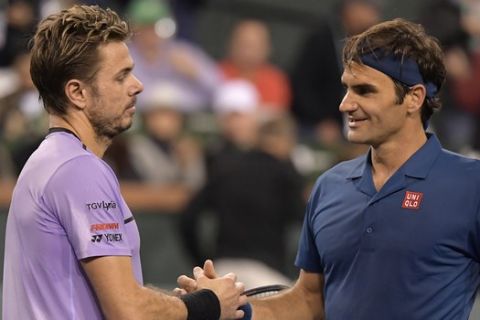 Stan Wawrinka left, congratulates Roger Federer at the BNP Paribas Open tennis tournament Tuesday, March 12, 2019 in Indian Wells, Calif. (AP Photo/Mark J. Terrill)