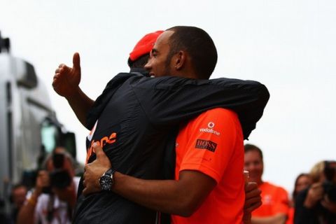 BUDAPEST, HUNGARY - JULY 31:  Jenson Button of Great Britain and McLaren celebrates winning his 200th Grand Prix with his team mate Lewis Hamilton following the Hungarian Formula One Grand Prix at the Hungaroring on July 31, 2011 in Budapest, Hungary.  (Photo by Vladimir Rys/Getty Images)