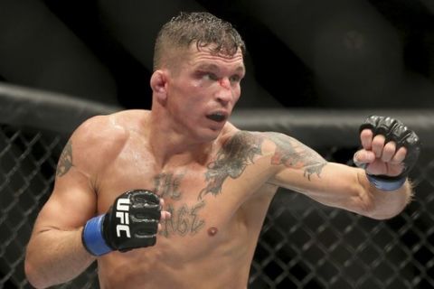 Darren Elkins, left, in action against Dennis Bermudez during their mixed martial arts bout at UFC on Fox 25, Saturday, July 22, 2017, in New York. Elkins won via split decision. (AP Photo/Steve Luciano)