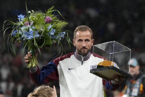 England's Harry Kane poses with award for his hundredth match the Group F UEFA Nations League soccer match between England and Finland at Wembley Stadium in London, Tuesday, Sept. 10, 2024. (AP Photo/Frank Augstein)