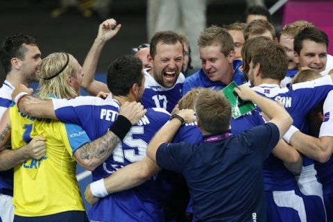 Iceland's players celebrate after defeating France in their men's handball preliminary match at the 2012 Summer Olympics, Saturday, Aug. 4, 2012, in London. (AP Photo/Vadim Ghirda)