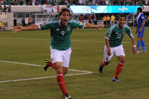 Mexico's Aldo De Nigris celebrates scoring with teammate Giovani dos Santos during the 2011 CONCACAF Gold Cup quarterfinal match Mexico against Guatemala on June 18, 2011 at New Meadowlands Stadium in East Rutherford, New Jersey. Mexico won 2-1.      AFP PHOTO/DON EMMERT (Photo credit should read DON EMMERT/AFP/Getty Images)