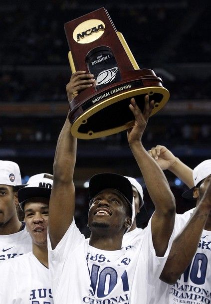 University of Connecticut Huskies guard Kemba Walker holds the NCAA trophy after the Huskies defeated the Butler Bulldogs to win the  men's final NCAA Final Four college basketball championship game in Houston, Texas, April 4, 2011. REUTERS/Jeff Haynes (UNITED STATES - Tags: SPORT BASKETBALL)