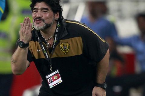 Al Wasl's head coach Diego Maradona of Argentina blows a kiss after scoring their third goal against Al Jazira during their Pro-League soccer match at Mohammad bin Zayed stadium in Abu Dhabi, September 15, 2011. REUTERS/Jumana El Heloueh (UNITED ARAB EMIRATES - Tags: SPORT SOCCER)