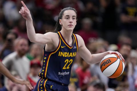 FILE - Indiana Fever guard Caitlin Clark (22) play sagainst the Washington Mystics in the first half of a WNBA basketball game in Indianapolis, Wednesday, July 10, 2024. Caitlin Clark and Angel Reese will once again step into the spotlight during All-Star Weekend with their matchup against Team USA. (AP Photo/Michael Conroy, File)