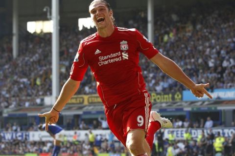 Liverpool's Andy Carroll celebrates after scoring his sides first goal during their English Premier League soccer match against Everton at Goodison Park in Liverpool, northern England October 1, 2011. REUTERS/Phil Noble (BRITAIN - Tags: SPORT SOCCER) FOR EDITORIAL USE ONLY. NOT FOR SALE FOR MARKETING OR ADVERTISING CAMPAIGNS. NO USE WITH UNAUTHORIZED AUDIO, VIDEO, DATA, FIXTURE LISTS, CLUB/LEAGUE LOGOS OR "LIVE" SERVICES. ONLINE IN-MATCH USE LIMITED TO 45 IMAGES, NO VIDEO EMULATION. NO USE IN BETTING, GAMES OR SINGLE CLUB/LEAGUE/PLAYER PUBLICATIONS