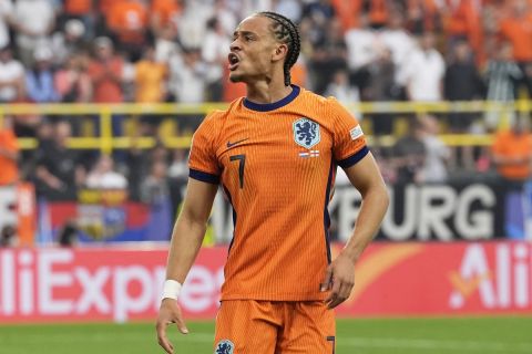 Xavi Simons of the Netherlands reacts after scoring the opening goal during a semifinal match between the Netherlands and England at the Euro 2024 soccer tournament in Dortmund, Germany, Wednesday, July 10, 2024. (AP Photo/Martin Meissner)