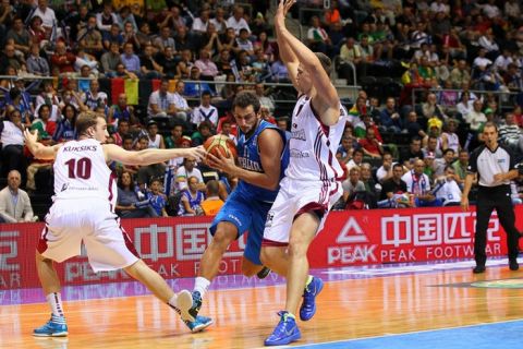 SIAULIAI, LITHUANIA - SEPTEMBER 02: Rihards Kuksiks (L) and Andrejs Selakovs of Latvia (R) defend against Marco Belinelli  of Italy (C) the EuroBasket 2011 first round group B match between Latvia and Italy at Siauliai Arena on September 2, 2011 in Siauliai, Lithuania. (Photo by Christof Koepsel/Bongarts/Getty Images)