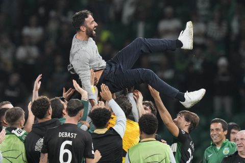 Sporting players toss coach Ruben Amorim during the UEFA Champions League opening phase match between Sporting and Manchester City in Lisbon, Portugal, Tuesday, Nov. 5, 2024. (AP Photo/Armando Franca)