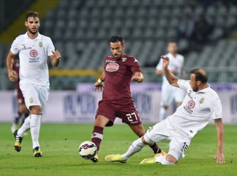 Torino's forward Fabio Quagliarella contrasted by Verona's defender Vangelis Moras during the Italian Serie A soccer match between Torino FC and Hellas Verona at Olimpico Stadium in Turin, 21 September 2014. ANSA/ ALESSANDRO DI MARCO 

