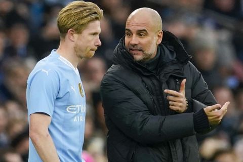 Manchester City's head coach Pep Guardiola, right, gives instructions to Manchester City's Kevin De Bruyne during the English FA Cup third round soccer match between Manchester City and Huddersfield Town, at the Etihad stadium in Manchester, England, Sunday, Jan. 7, 2024. (AP Photo/Dave Thompson)