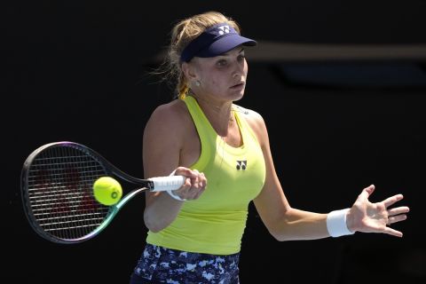 Dayana Yastremska of Ukraine plays a forehand return to Madison Brengle of the U.S. during their first round match at the Australian Open tennis championships in Melbourne, Australia, Monday, Jan. 17, 2022. (AP Photo/Simon Baker)