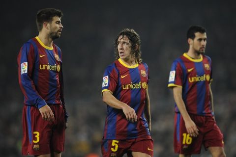 BARCELONA, SPAIN - JANUARY 16:  Gerard Pique (L), Carles Puyol (C) and Sergio Busquets of FC Barcelona look on during the La Liga match between FC Barcelona and Malaga at Nou Camp on January 16, 2011 in Barcelona, Spain. Barcelona won 4-1.  (Photo by David Ramos/Getty Images)