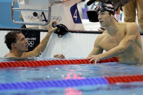 United States' Michael Phelps, right, and teammate Ryan Lochte watch the score board after their first and second place finish in the men's 200-meter individual medley swimming final at the Aquatics Centre in the Olympic Park during the 2012 Summer Olympics in London, Thursday, Aug. 2, 2012. (AP Photo/Matt Slocum)