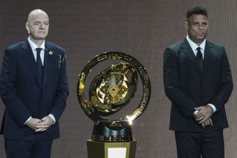 FIFA President Gianni Infantino' and Former professional Brazilian soccer player Ronaldo present a new trophy during the draw for the 2025 FIFA Club World Cup soccer tournament, Thursday, Dec. 5, 2024, in Miami. (AP Photo/Rebecca Blackwell)