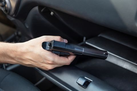 Driver Taking Handgun From Glovebox Compartment Inside Car