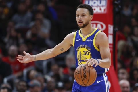 Golden State Warriors guard Stephen Curry brings the ball up court against the Chicago Bulls during the first half of an NBA basketball game, Monday, Oct. 29, 2018, in Chicago. (AP Photo/Kamil Krzaczynski)