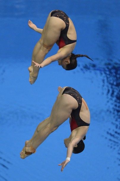 China's Wu Minxia and He Zi dive during the women's synchronised 3m springboard diving event at the London 2012 Olympic Games on July 29, 2012 in London.  AFP PHOTO / FABRICE COFFRINI        (Photo credit should read FABRICE COFFRINI/AFP/GettyImages)