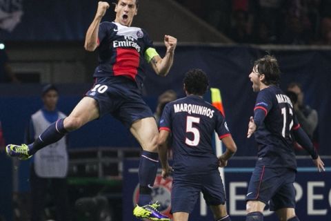 Paris Saint-Germain's Swedish forward Zlatan Ibrahimovic (L) celebrates after scoring during a Group C Champions League football match between Benfica and Paris Saint Germain on October 2, 2013 at the Parc des Princes stadium in Paris.  
  AFP PHOTO / FRANCK FIFE        (Photo credit should read FRANCK FIFE/AFP/Getty Images)