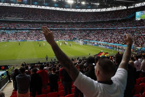 England fans cheer for their national team during the Euro 2020 soccer championship round of 16 match between England and Germany, at Wembley stadium, in London, Tuesday, June 29, 2021. (Matthew Childs/Pool via AP)