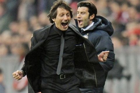 Milan's head coach Leonardo,l eft, and Luis Figo react at the sideline after winning the Champions League round of 16 econd leg soccer match between FC Bayern Munich and Inter Milan in Munich southern Germany, Tuesday, March 15, 2011. (AP Photo/Kerstin Joensson)