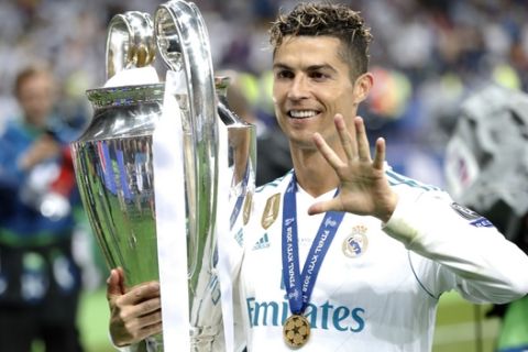 Real Madrid's Cristiano Ronaldo celebrates with the trophy after winning the Champions League Final soccer match between Real Madrid and Liverpool at the Olimpiyskiy Stadium in Kiev, Ukraine, Saturday, May 26, 2018. (AP Photo/Pavel Golovkin)