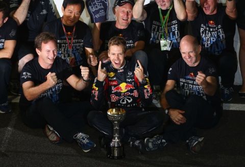 SUZUKA, JAPAN - OCTOBER 09:  Sebastian Vettel (C) of Germany and Red Bull Racing celebrates in the pitlane with Red Bull Racing Team Principal Christian Horner (L), Red Bull Racing Chief Technical Officer Adrian Newey (R) and the rest of his team mates after finishing third to secure his second F1 World Drivers Championship during the Japanese Formula One Grand Prix at Suzuka Circuit on October 9, 2011 in Suzuka, Japan.  (Photo by Clive Mason/Getty Images)