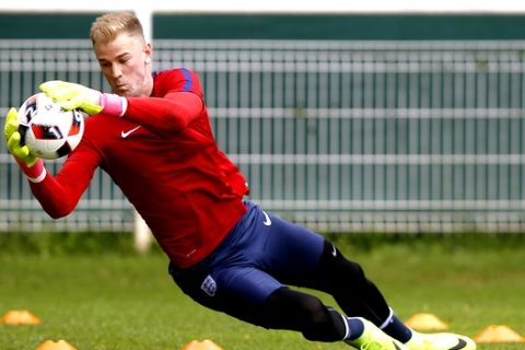 FILE - This is a Sunday, June 26, 2016.  file photo of England goalkeeper Joe Hart as he makes a save during a training session in Chantilly, France. England goalkeeper Joe Hart has completed Wednesday, Aug. 31, 2016, a loan move to Torino from Manchester City. (AP Photo/Kirsty Wigglesworth, File)