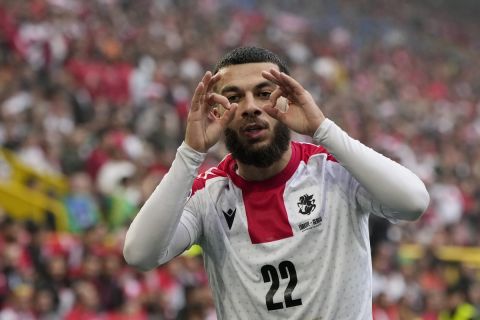 Georgia's Georges Mikautadze celebrates after scoring his side's opening goal during a Group F match between Turkey and Georgia at the Euro 2024 soccer tournament in Dortmund, Germany, Tuesday, June 18, 2024. (AP Photo/Alessandra Tarantino)