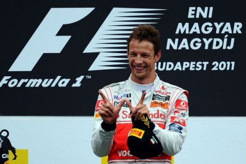 BUDAPEST, HUNGARY - JULY 31:  Jenson Button of Great Britain and McLaren celebrates on the podium after winning his 200th Grand Prix during the Hungarian Formula One Grand Prix at the Hungaroring on July 31, 2011 in Budapest, Hungary.  (Photo by Lars Baron/Getty Images)