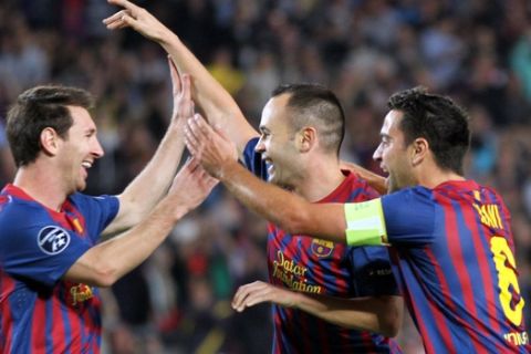 FC Barcelona's Andres Iniesta, center, celebrates with teammates Lionel Messi, left, of Argentina and Xavi Hernandez after scoring during a Champions League, Group H, soccer match against Viktoria Plzen, at the Camp Nou, in Barcelona, Spain, Wednesday, Oct. 19, 2011. (AP Photo/Felice Calabro')