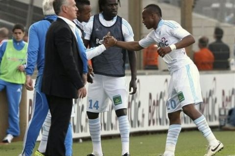 Marseille players react after Marseille's Ghanaian forward Andre Ayew, right, scored against Nice during their French League One soccer match, at the Velodrome Stadium, in Marseille, southern France, Wednesday, April 27, 2011. (AP Photo/Claude Paris)