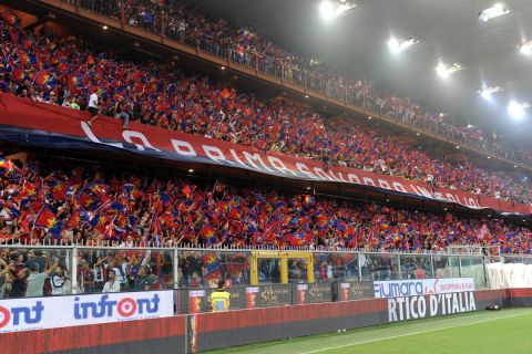 Fans cheer during a Serie A soccer match between Genoa and Sampdoria, at Genoa's Luigi Ferraris Stadium, Italy, Sunday, Sept. 28, 2014. (AP Photo/Tano Pecoraro)