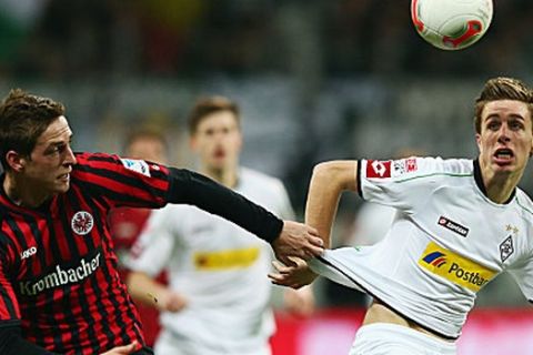 FRANKFURT AM MAIN, GERMANY - MARCH 01: Patrick Herrmann (R) of Moenchengladbach is challenged by Bastian Oczipka of Frankfurt during the Bundesliga match between Eintracht Frankfurt and Borussia Moenchengladbach at Commerzbank-Arena on March 1, 2013 in Frankfurt am Main, Germany.  (Photo by Alex Grimm/Bongarts/Getty Images)