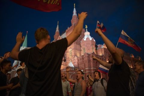 Fans celebrate in the Red Square after Russia defeated Spain in their round of 16 match at the 2018 soccer World Cup in Moscow, Russia, Sunday, July 1, 2018. (AP Photo/Victor R. Caivano)