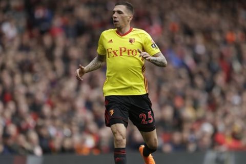 Watford's Jose Holebas reacts after clashing with Arsenal's Mesut Ozil during the English Premier League soccer match between Arsenal and Watford at the Emirates stadium in London, Sunday, March 11, 2018. (AP Photo/Matt Dunham)