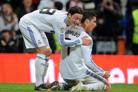 MADRID, SPAIN - FEBRUARY 06: Mesut Ozil (L) of Real Madrid congratulates Cristiano Ronaldo after Ronaldo scored Real's third goal during the La Liga match between Real Madrid and Real Sociedad at Estadio Santiago Bernabeu on February 6, 2011 in Madrid, Spain.  (Photo by Denis Doyle/Getty Images)