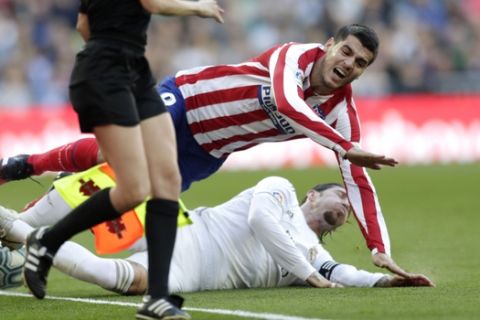 Atletico Madrid's Alvaro Morata, above, is tackled by Real Madrid's Sergio Ramos during a Spanish La Liga soccer match between Real Madrid and Atletico Madrid at the Santiago Bernabeu stadium in Madrid, Saturday, Feb. 1, 2020. (AP Photo/Bernat Armangue)