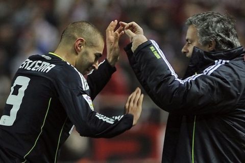 Real Madrid's Portuguese coach Jose Mourinho (R) celebrates with Real Madrid's French forward Karim Benzema (L) after scoring during the Spanish King's Cup (Copa del Rey) football match Sevilla FC vs Real Madrid on January 26, 2011 at the Ramon Sanchez Pizjuan stadium in Sevilla.AFP PHOTO/ CRISTINA QUICLER (Photo credit should read CRISTINA QUICLER/AFP/Getty Images)