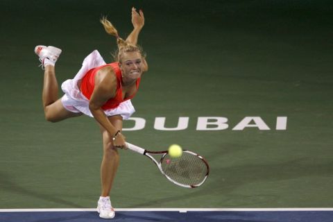 Caroline Wozniacki of Denmark serves the ball to Ayumi Morita of Japan during their match at the WTA Dubai Tennis Championships February 17, 2011. REUTERS/Jumana El-Heloueh (UNITED ARAB EMIRATES - Tags: SPORT TENNIS)