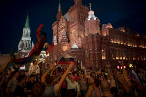 Fans celebrate in the Red Square after Russia defeated Spain in their round of 16 match at the 2018 soccer World Cup in Moscow, Russia, Sunday, July 1, 2018. (AP Photo/Victor R. Caivano)