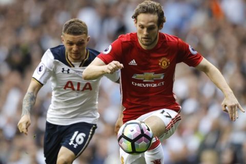 Manchester United's Daley Blind, right, competes for the ball with Tottenham's Kieran Trippier during the English Premier League soccer match between Tottenham Hotspur and Manchester United at White Hart Lane stadium in London, Sunday, May 14, 2017. (AP Photo/Frank Augstein)