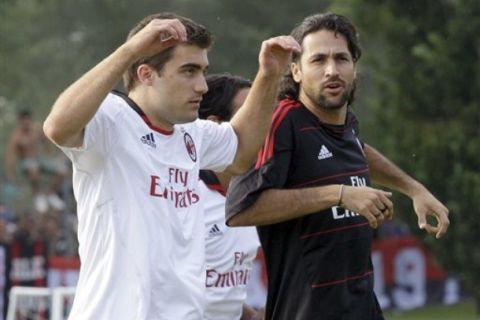 Newly hired AC Milan  players Sokratis Papastathopoulos, of Greece, left, and Mario Alberto Yepes, of Colombia, warm up the first team training session in view of the upcoming Italian Serie A soccer season at the Milanello sporting center, in Carnago, Italy, Tuesday, July 20, 2010. (AP Photo/Luca Bruno)