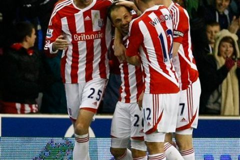 Stoke City's Matthew Etherington, second left, celebrates with team mate Peter Crouch, left, after scoring a goal against Tottenham Hotspur during their English Premier League soccer match at Britannia Stadium, Stoke on Trent, England, Sunday Dec. 11, 2011. (AP Photo/Tim Hales)