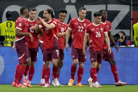 Switzerland's Dan Ndoye, center, celebrates after scoring his side's opening goal with teammates during a Group A match between Switzerland and Germany at the Euro 2024 soccer tournament in Frankfurt, Germany, Sunday, June 23, 2024. (AP Photo/Martin Meissner)