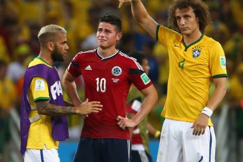 FORTALEZA, BRAZIL - JULY 04:  Dani Alves (L) and David Luiz of Brazil console James Rodriguez of Colombia after Brazil's 2-1 win during the 2014 FIFA World Cup Brazil Quarter Final match between Brazil and Colombia at Castelao on July 4, 2014 in Fortaleza, Brazil.  (Photo by Robert Cianflone/Getty Images)