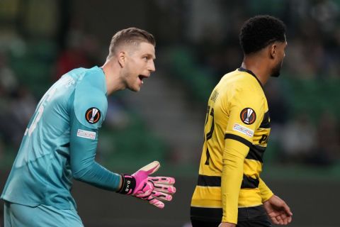 Young Boys' goalkeeper David van Ballmoos, left, talks to Young Boys' Saidy Janko during the Europa League playoff second leg soccer match between Sporting CP and Young Boys at the Alvalade stadium in Lisbon, Thursday, Feb. 22, 2024. (AP Photo/Armando Franca)