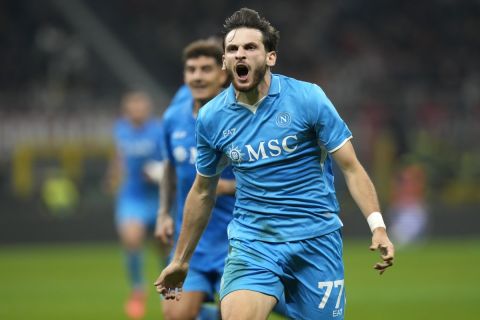 Napoli's Khvicha Kvaratskhelia, centre, celebrates after scoring his side's second goal during the Serie A soccer match between AC Milan and Napoli at the San Siro stadium, in Milan, Italy, Tuesday, Oct. 29, 2024. (AP Photo/Luca Bruno)