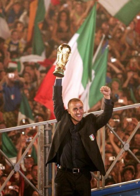 ROME, ITALY - JULY 10: Italian soccer fans celebrate as the teams captain Fabio Cannavaro displays the FIFA World Cup Trophy at the Circo Massimo on July 10, 2006 in Rome, Italy. (Photo by Salvatore Laporta/Getty Images)