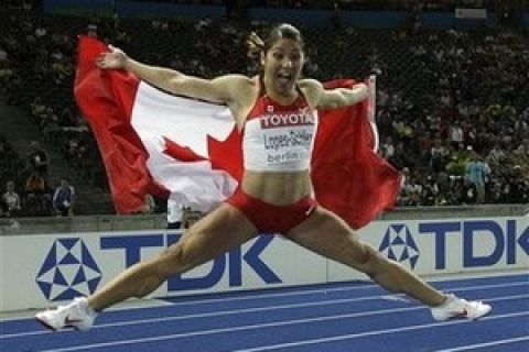 Canada's Priscilla Lopes-Schliep celebrates after winning the silver medal in the final of the Women's 100m Hurdles during the World Athletics Championships in Berlin on Wednesday, Aug. 19, 2009.  (AP Photo/David J. Phillip)